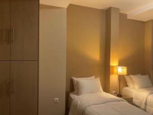 A bed or beds in a room at Athens Gem