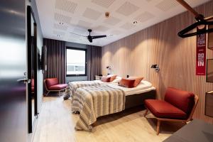 a hotel room with two beds and two chairs at Centro Hotel Turku in Turku