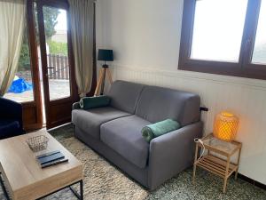 a living room with a couch and a table at Studio de la mer in La Croix-Valmer