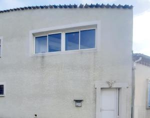 a white building with a window and a door at appartement 45m2 parking gratuit en plein centre ville in Valras-Plage