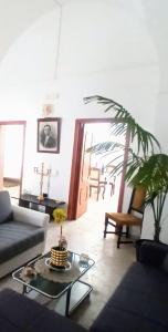 a living room with a couch and a table at CASA VACANZA NONNA EMMA in Lizzano