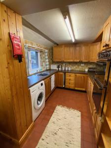 a kitchen with a washer and dryer in it at Remarkable 3-Bed House in Millom in Millom
