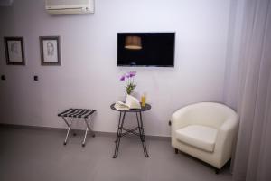 a living room filled with furniture and a tv at Hotel Bajamar Centro in Nerja