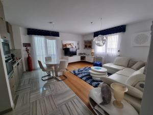 a living room with a couch and a table at Charming apartment, 2 garage parking in Split