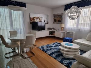 a living room with a table and a couch at Charming apartment, 2 garage parking in Split