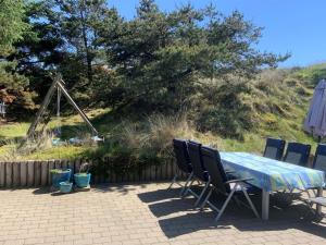 a table and chairs sitting on a patio at Holiday Home Gudrid - all inclusive - 500m from the sea by Interhome in Fanø