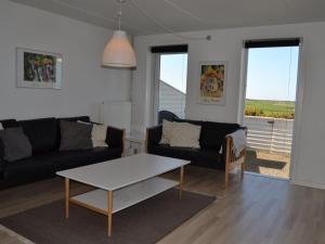 a living room with a couch and a coffee table at Apartment Drita - 2-3km from the sea in Western Jutland by Interhome in Sønderby