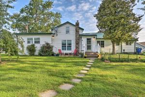 a house with a grass yard with a pathway at Lakeside Kent Home with Pier and Boat Ramp Access in Waterport