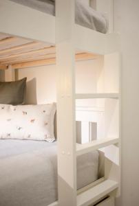 a bedroom with bunk beds and a bed with a pillow at ALTAMIRA FAMILY APARTMENT El Duque in Adeje