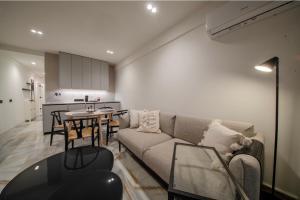 a living room with a couch and a table at ALTAMIRA FAMILY APARTMENT El Duque in Adeje