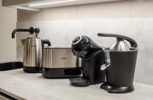 a kitchen counter with two coffee makers and a mixer at ALTAMIRA FAMILY APARTMENT El Duque in Adeje