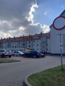 a parking lot with cars parked in front of buildings at Apartament Sobieskiego in Zabrze