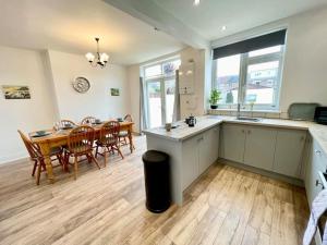 a kitchen and dining room with a table and a dining room at City Haven Luxurious 3-Bed Retreat in Portsmouth