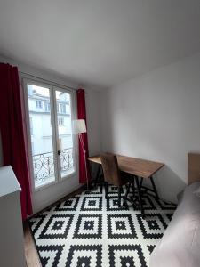 a small room with a table and a window at Charming apartment in Montmartre in Paris