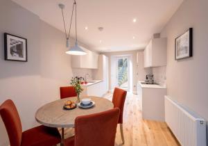 a kitchen and dining room with a table and chairs at Luxury apartment, Stafford Street in Edinburgh