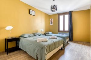 een slaapkamer met een bed met twee handdoeken erop bij Maison du capitole in Narbonne