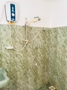 a bathroom with a sink and a toilet at Sun Rise Hostel in Negombo