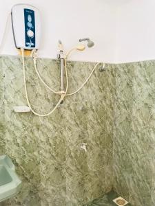 a bathroom with a sink and a toilet at Sun Rise Hostel in Negombo