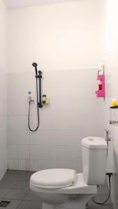 a bathroom with a toilet and a shower at HAPDESKO HOMESTAY in Batam Center