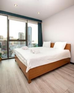 a bedroom with a large bed with a large window at Marina Green Suite & Residence in Trabzon