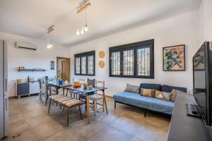 a living room with a table and a blue couch at La Parva - Casa rural Eralta in Dúrcal