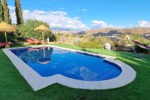 a swimming pool in the middle of a yard at Villa à la campagne avec vues, piscine, jaccuzi, sauna in Alora