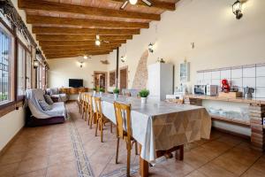 a large kitchen with a long table and chairs at Mas del Vedell in L'Ampolla