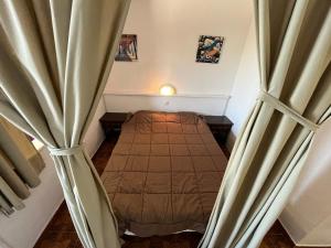 a bedroom with a bed in a room with curtains at Apartamentos Eurhostal Altamar in Alcossebre