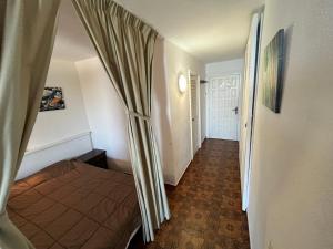 a bedroom with a bed with a curtain in it at Apartamentos Eurhostal Altamar in Alcossebre