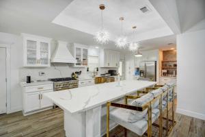 a kitchen with white cabinets and a white counter top at Centrally Located Eagle Pass Home with Pool! in Eagle Pass
