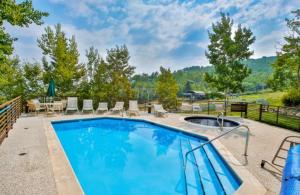 a swimming pool with chairs and a table at Snowmass Village, 3 Bedroom at Chamonix Ski-in Ski-out in Snowmass Village
