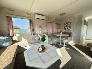 a living room with a couch and a table at Caravans 10 min to Tsonevo Lake & 35 min to Black Sea 