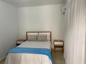 Postel nebo postele na pokoji v ubytování Hostal El Rinconcito Cibaeño