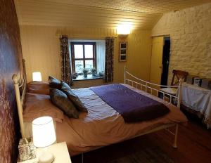 a bedroom with a large bed with pillows on it at The Ruah - Clifftop Retreat in Whitehall