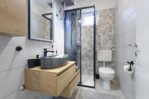 a bathroom with a sink and a toilet at Apartmani Tena in Selce