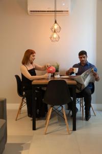 a man and a woman sitting at a table at Art Inn Porto in Rio de Janeiro