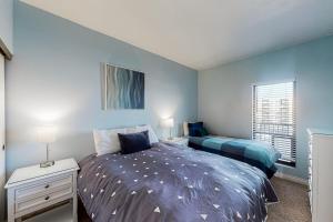 a bedroom with a bed and a desk with two lamps at Sand & Sea: Paradise on the Prom (516) in Seaside