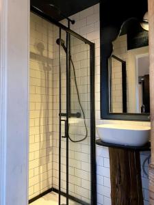 a bathroom with a sink and a glass shower at Charming, rustic & well equipped garden cottage in Alyth