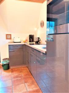 a kitchen with a stainless steel refrigerator and appliances at Töpferweg 06 Georgia in Ahrenshoop