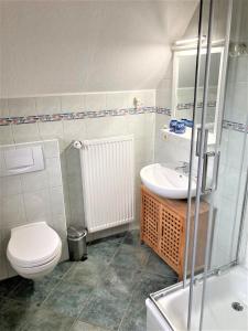 a bathroom with a toilet and a sink at Töpferweg 06 Georgia in Ahrenshoop