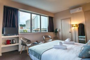 A bed or beds in a room at Athens Gem