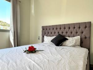 a bedroom with a bed with a flower on it at Yamina Rooftop Residence in Agia Pelagia