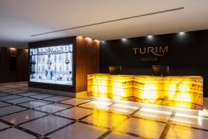 a lobby of a hotel with a sign on the wall at TURIM Oporto Hotel in Porto