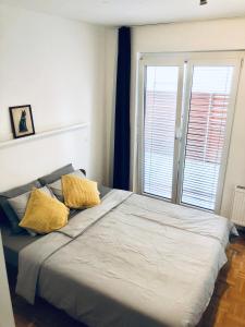 - une chambre avec un grand lit et 2 oreillers jaunes dans l'établissement Jenny Apartment with Jacuzzi, à Brezovica