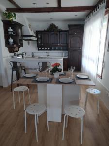 a kitchen with a table and stools in a room at A Casa do Choco in Redondela