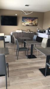 a restaurant with tables and chairs and a dining room at Prealpina Hotel in Bagnolo Piemonte