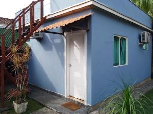 a blue house with a staircase and a door at Espaço aconchegante Blumenau in Blumenau