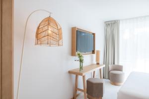 a hotel room with a desk and a window at H&ocirc;tel Ibaia in Hendaye