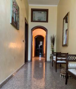 a hallway with a couch and a chair in a room at B & B Il Giardino in Noto