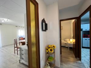 a room with a dresser a mirror and a bedroom at Apartamento Sedassos Circo Romano in Tarragona
